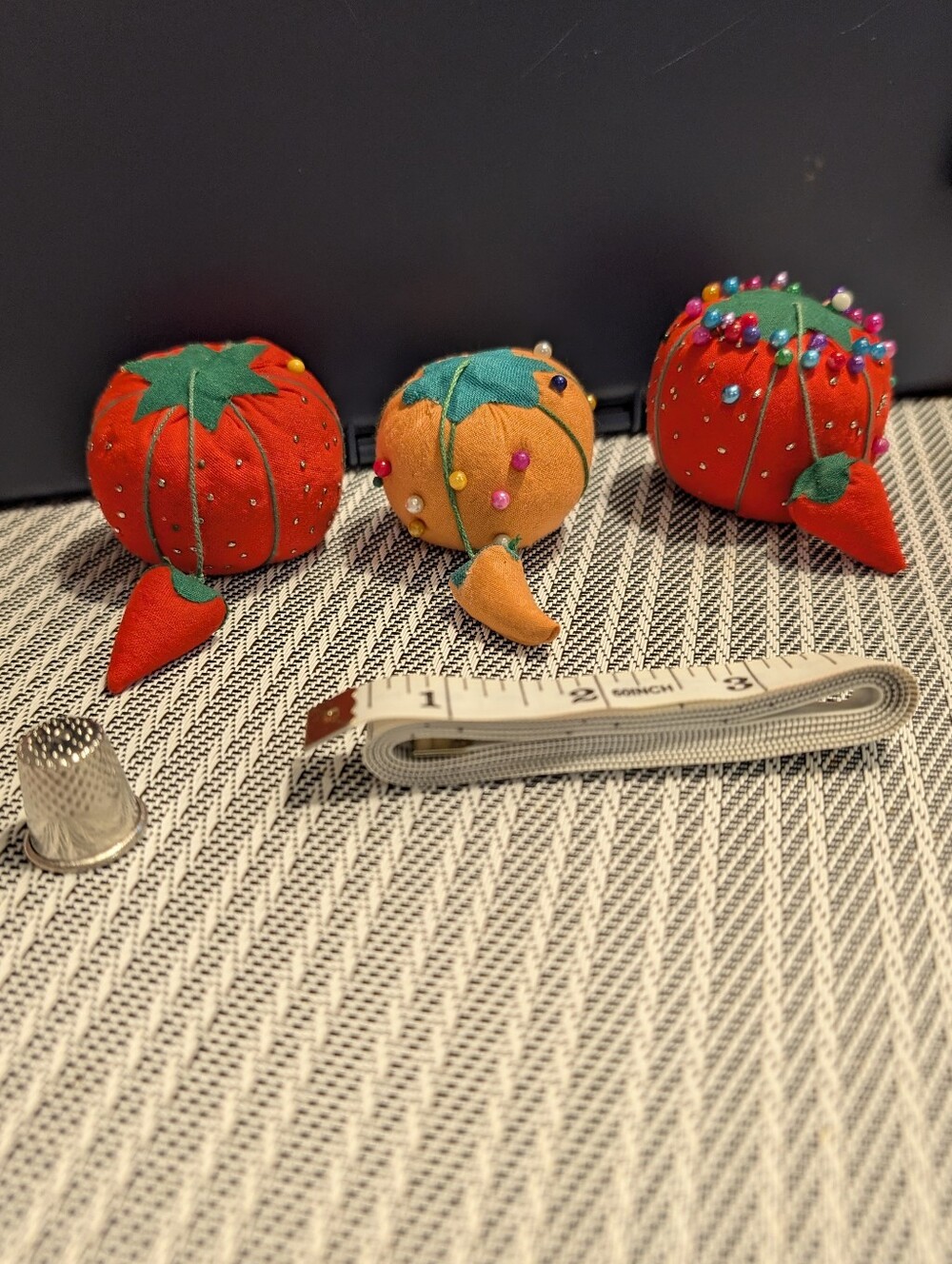 Three vintage tomato pincushions + More